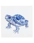 Decorative turtle with blue floral patterns on a tile on a white background