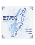 A square white tile featuring a blue watercolor-style map of New York City with the New York Marathon route outlined in dark blue. The text is personalisable.