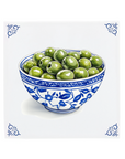 Bowl of green olives on a decorative delft blue tile with traditional blue patterns