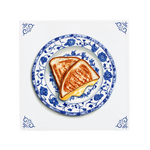 Two pieces of grilled cheese toastie on a decorative blue and white plate with floral patterns, on a dutch delft blue tile.