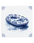 Ceramic Dutch Tile with decorative corner ornaments, featuring a Delft blue inflatable boat design.