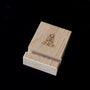Wooden tile stand with The Dutch Tile Project logo on a dark background