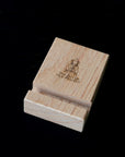 Wooden tile stand with The Dutch Tile Project logo on a dark background