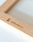 Back view detail of a horizontal wooden tile frame, showing The Dutch Tile Project logo and website.