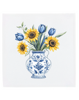 Vase with blue tulips and yellow sunflowers in a delft blue vase on a tile