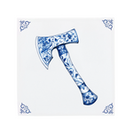 An axe on a Delft Blue ceramic tile with decorative corner ornaments