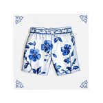 A pair of boxer shorts on a Delft Blue ceramic tile with decorative corner ornaments